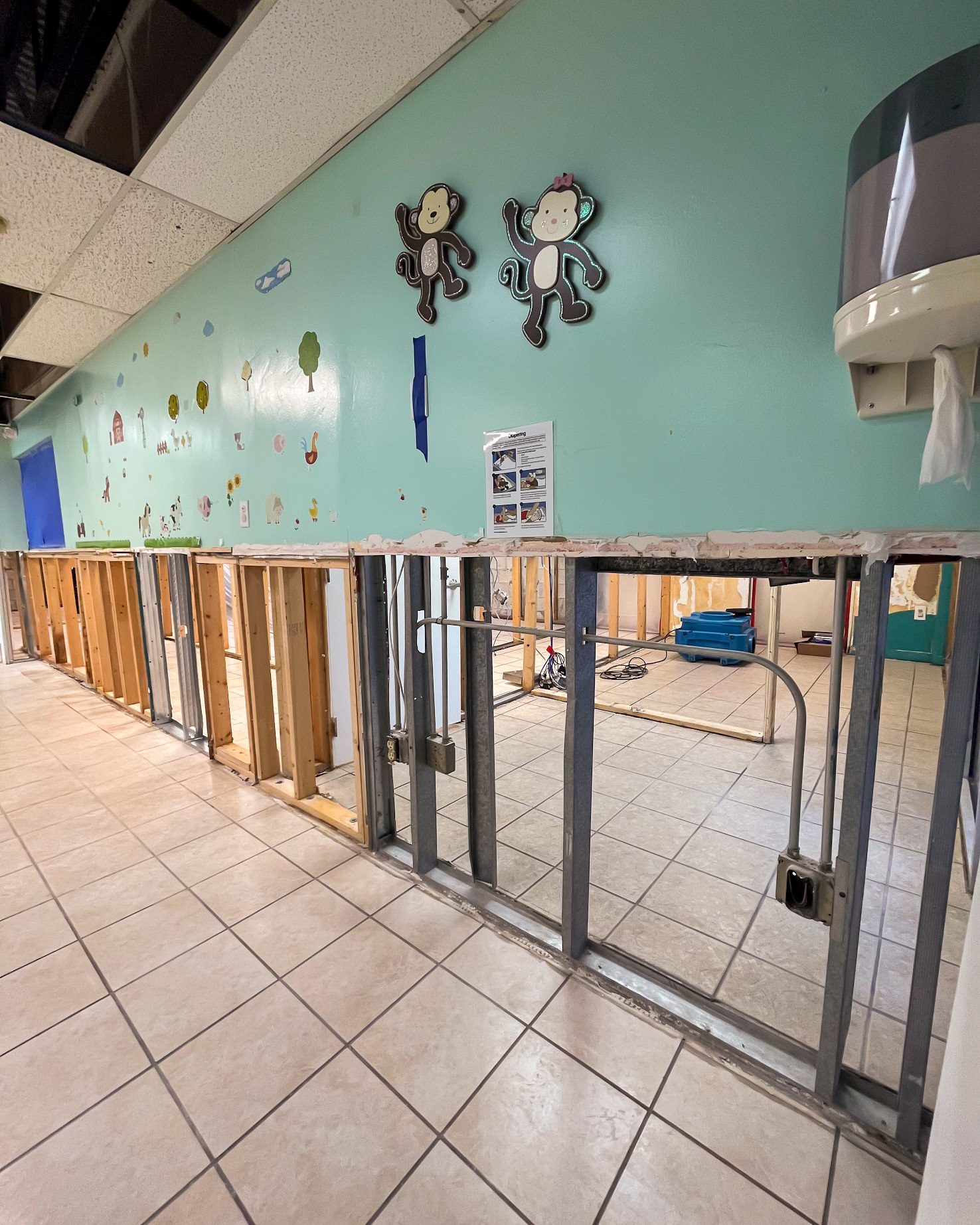 Commercial water damage — gutted walls and drying equipment in daycare