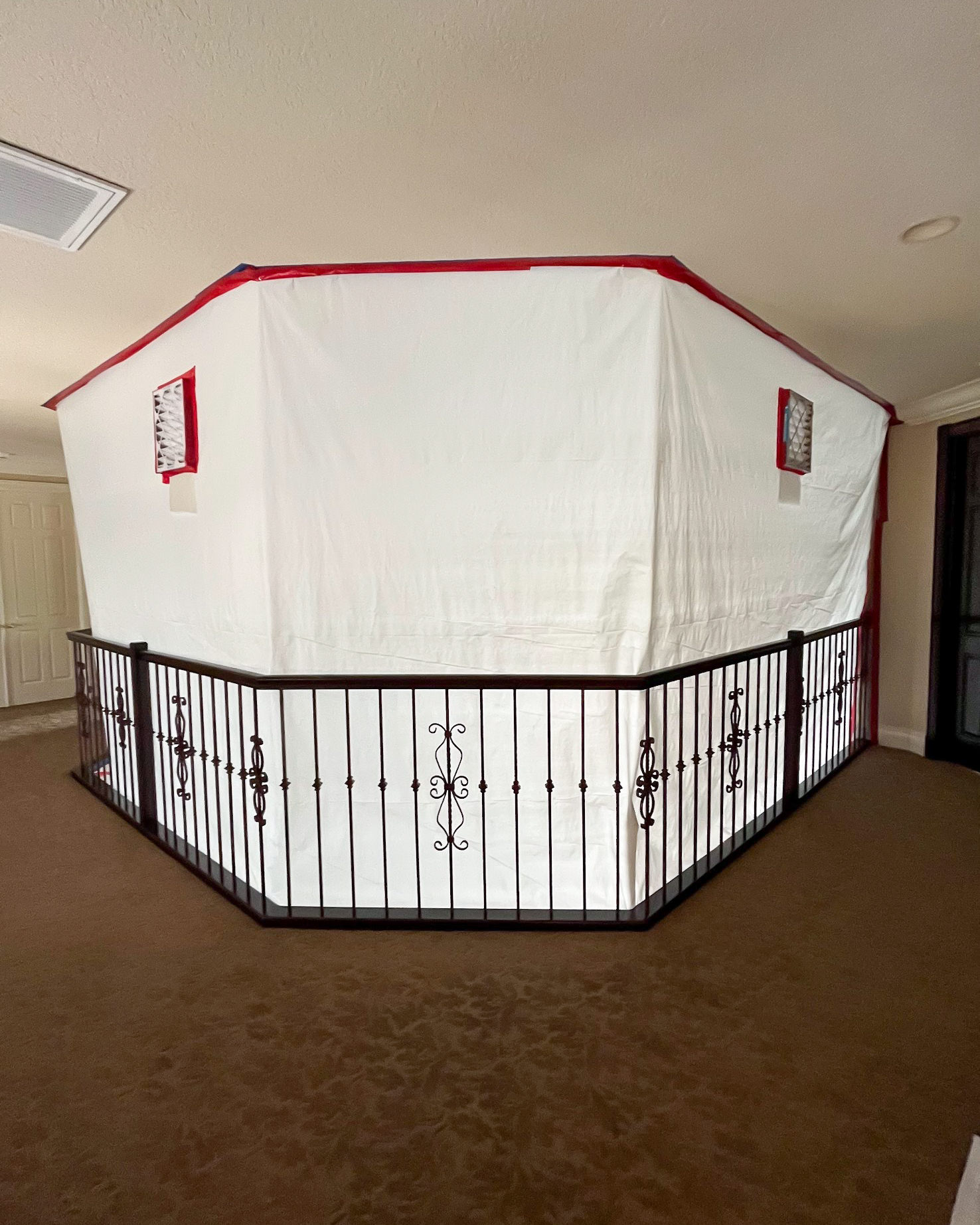 Full containment tent setup with HEPA filtration in upstairs room