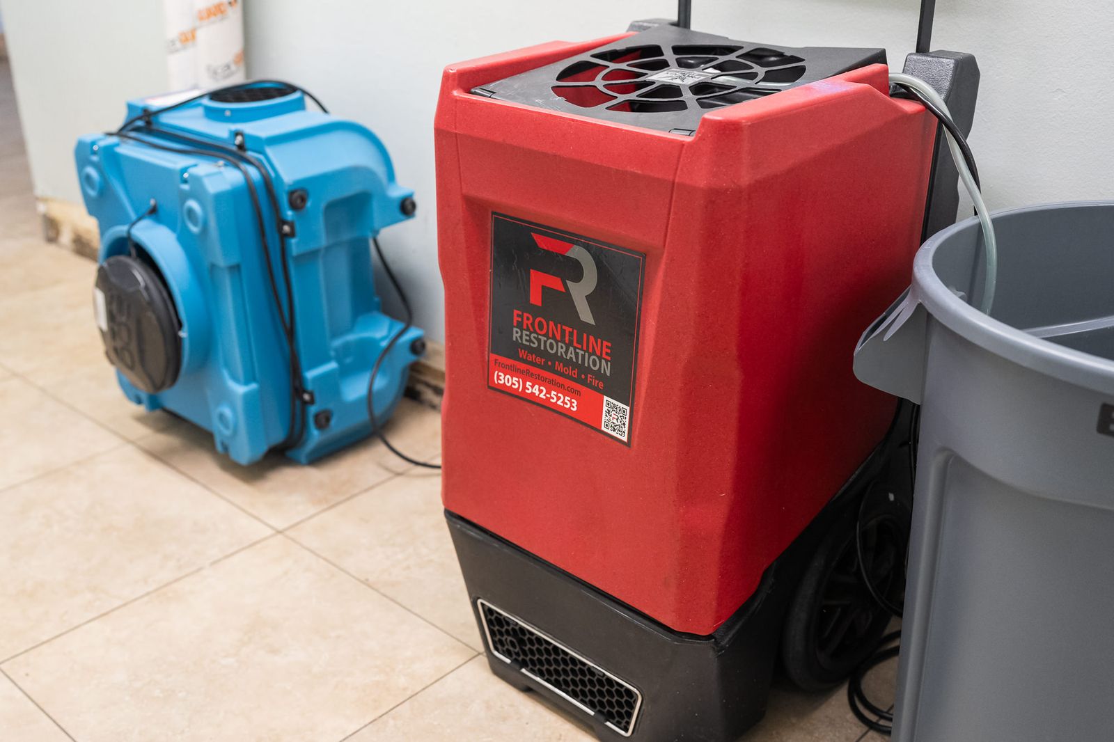 Air mover and dehumidifier positioned together during structural drying