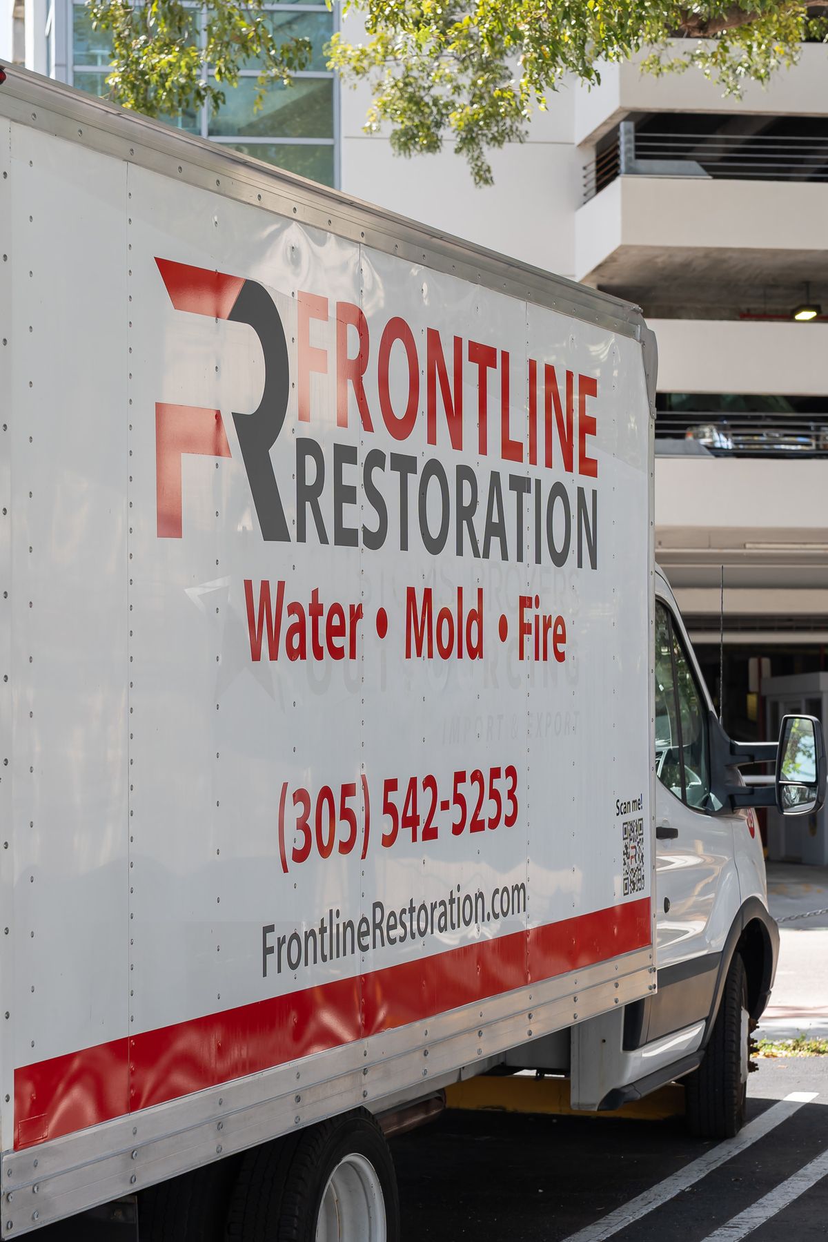 Frontline Restoration box truck showing contact details on the side panel