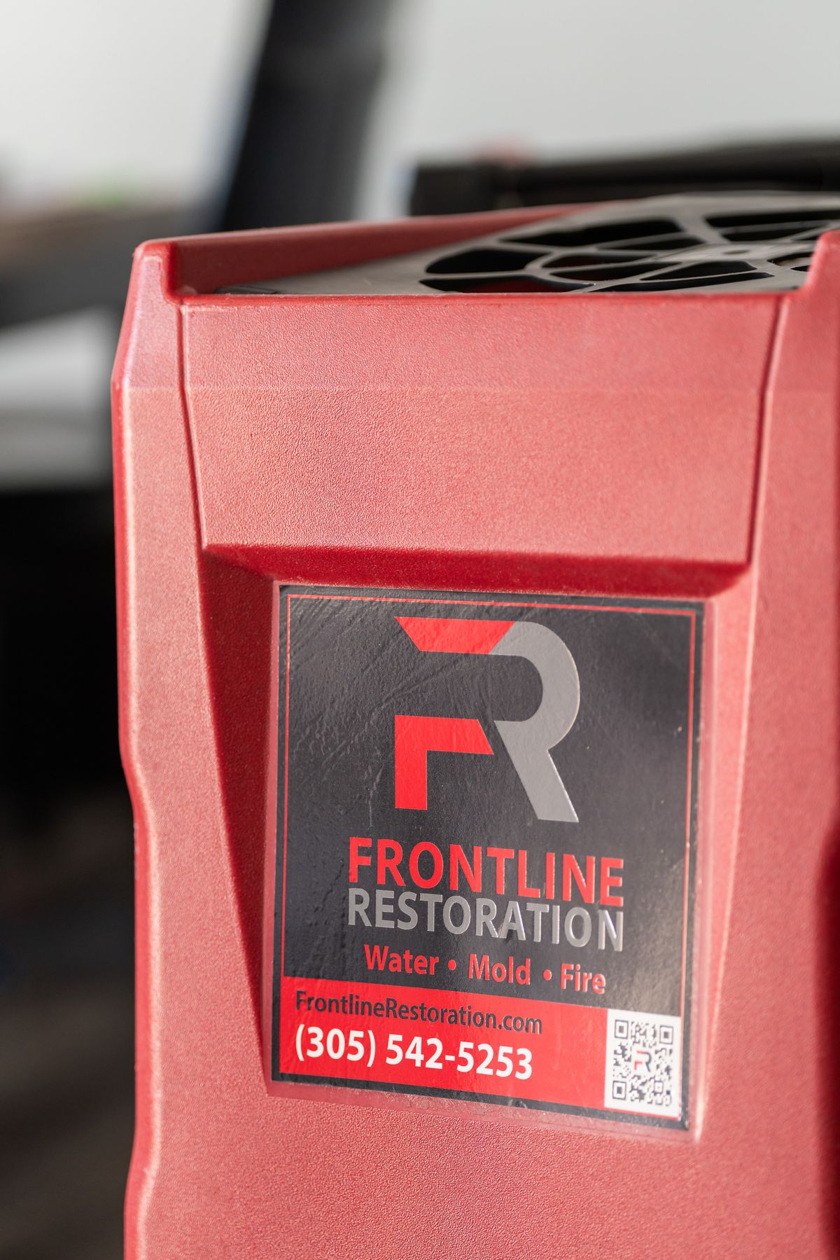 Close view of a Frontline Restoration dehumidifier in use