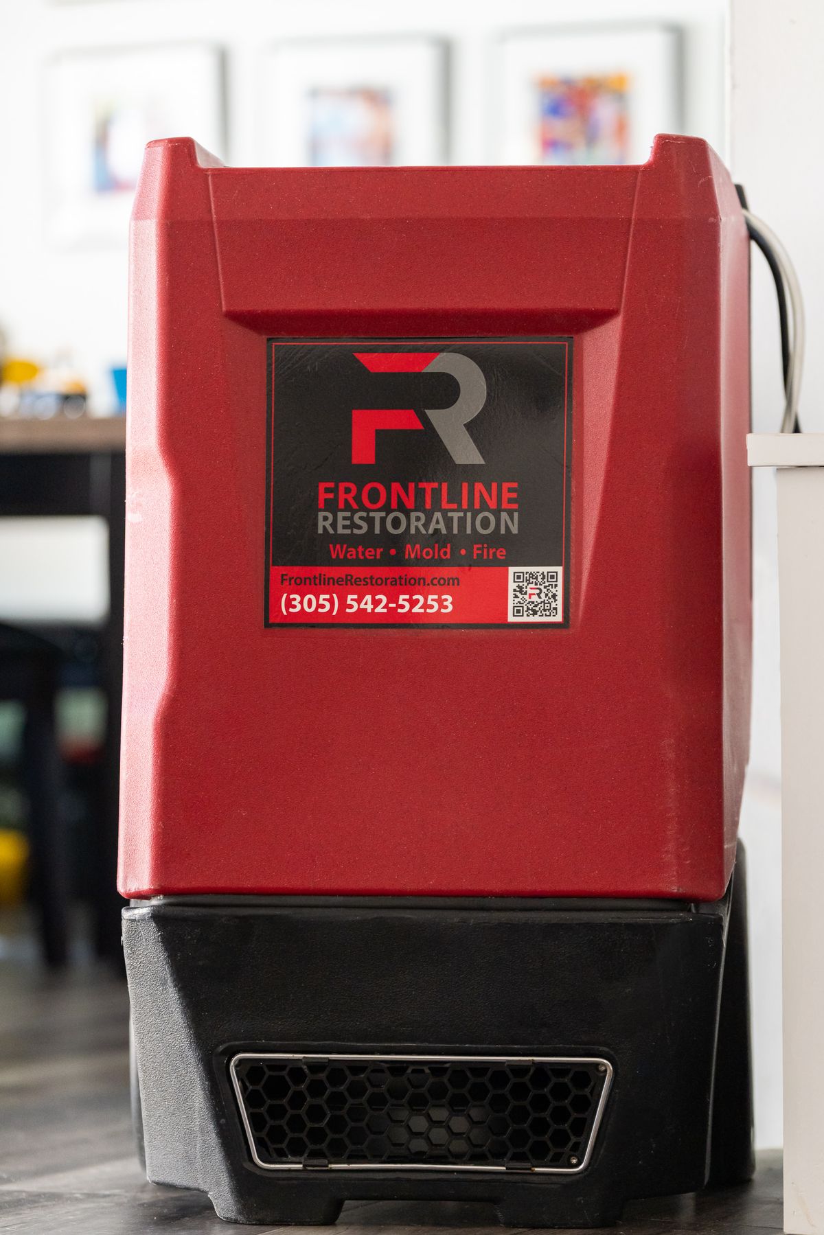 Dehumidifier positioned inside a residence during drying