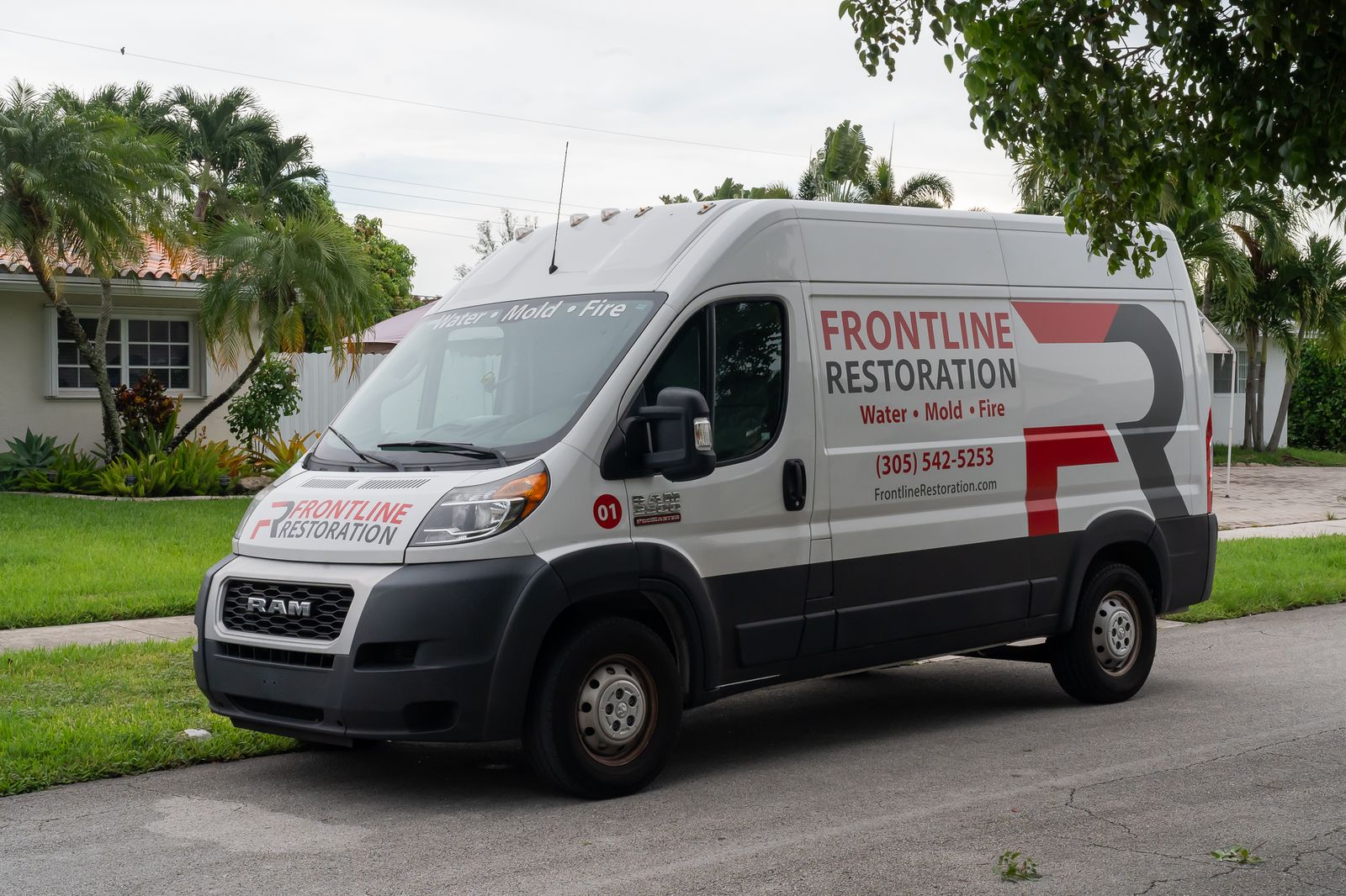 Branded Frontline Restoration van parked on a residential street